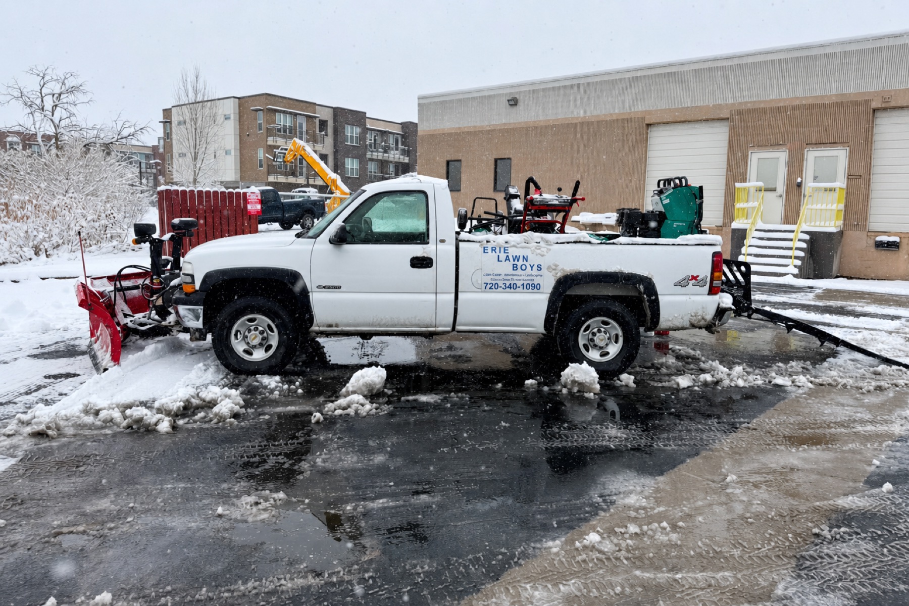 Erie Lawn Boys commercial plow truck and snow equipment at a Boulder County property